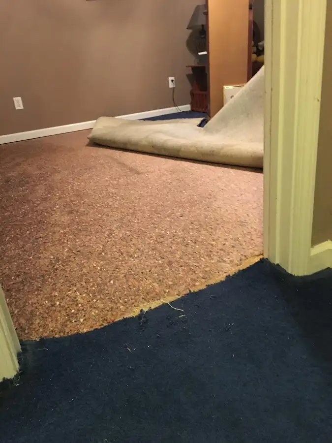 Carpet pad removal revealing water damage during Drying & Dehumidification in Orangetown